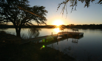 sunset on steel floating dock with benches